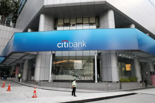 Wall Street traders watch stock tickers as US banks post record dealmaking profits